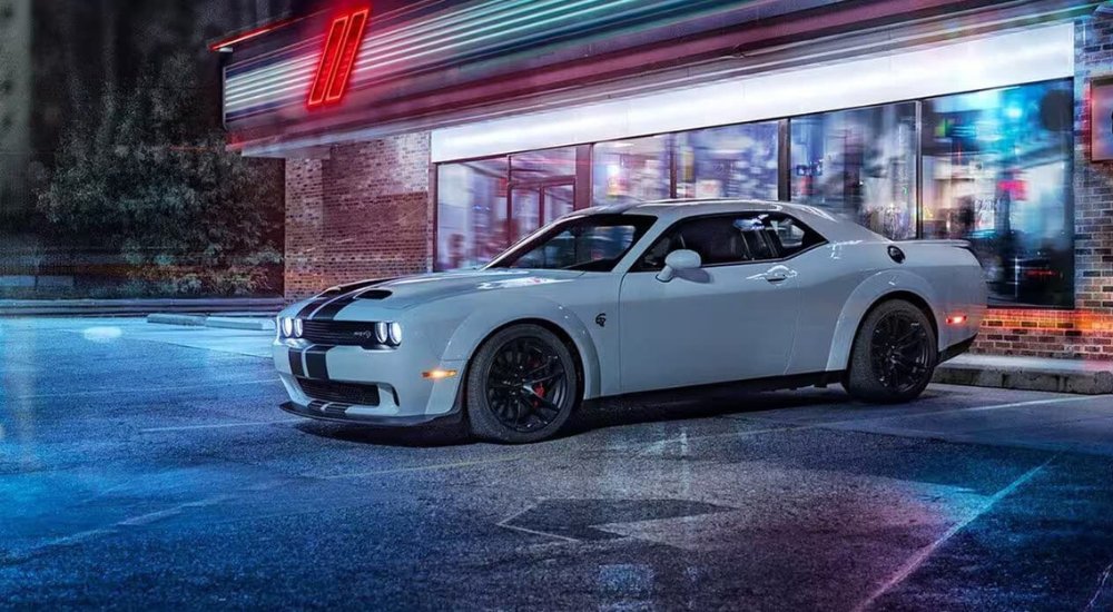 A grey 2021 Dodge Challenger SRT Hellcat is shown near a convenience store after visiting a Dodge dealer.