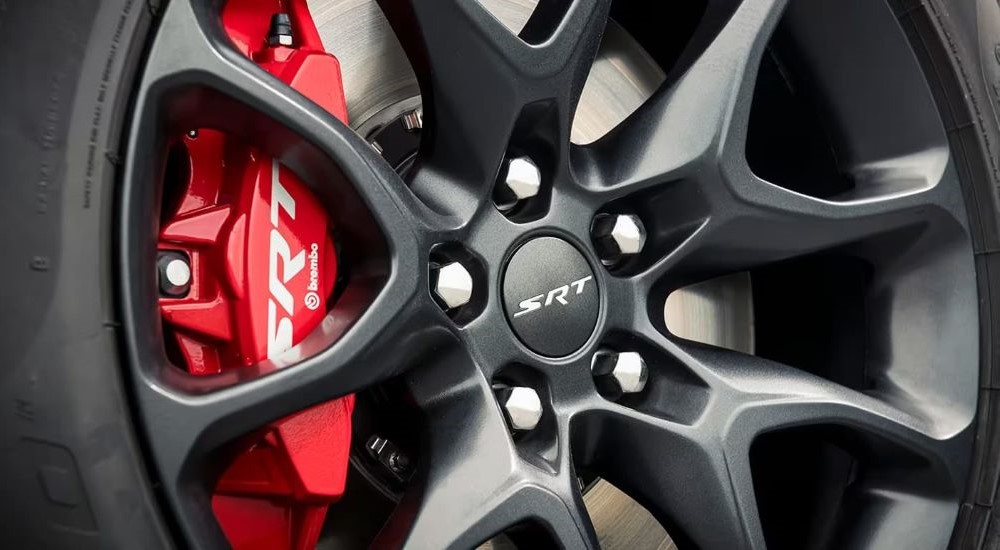 A close up shows the wheel and red Brembo caliper on a 2024 Dodge Durango SRT.