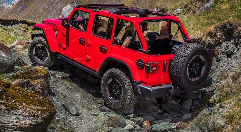 A red 2022 Jeep Wrangler Rubicon is shown from the rear at an angle.