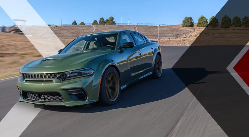 A green 2023 Dodge Charger Swinger Edition is shown from the front at an angle after leaving a dealer that has a Dodge Charger for sale.