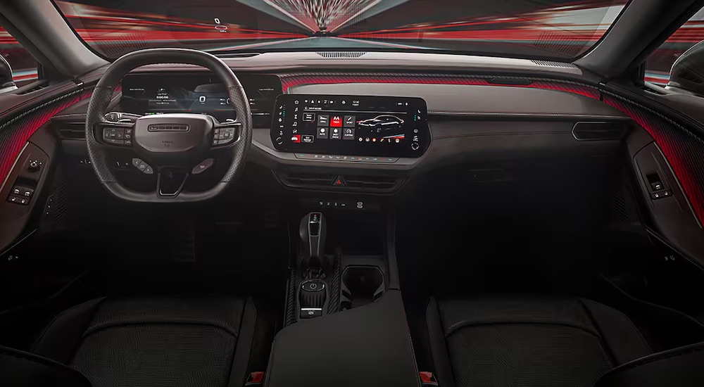 The black and red interior of a 2024 Dodge Charger is shown from above the center console.
