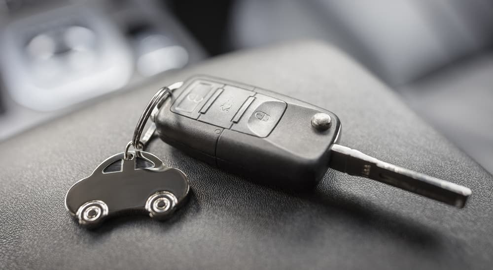 A close-up on a key fob sitting in a car.