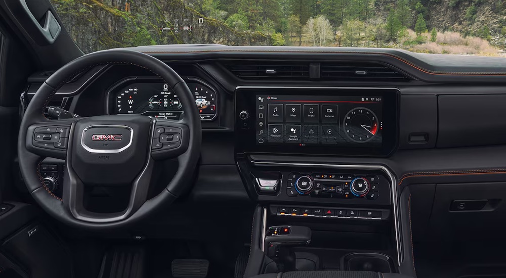 The steering wheel and infotainment screen in a 2024 GMC Sierra 1500 AT4.