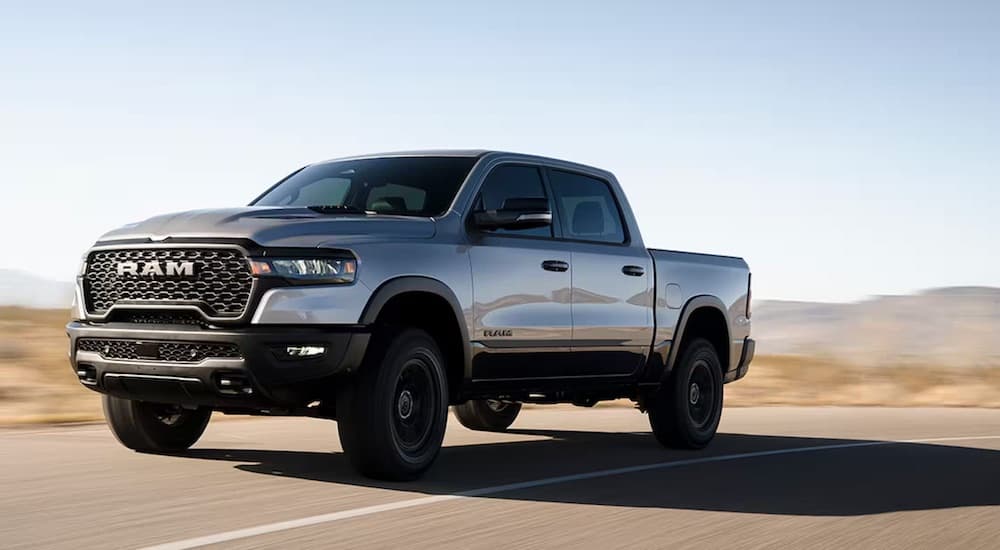 A silver 2025 Ram 1500 Rebel is shown from the front at an angle after leaving a Ram dealer near Metamora.