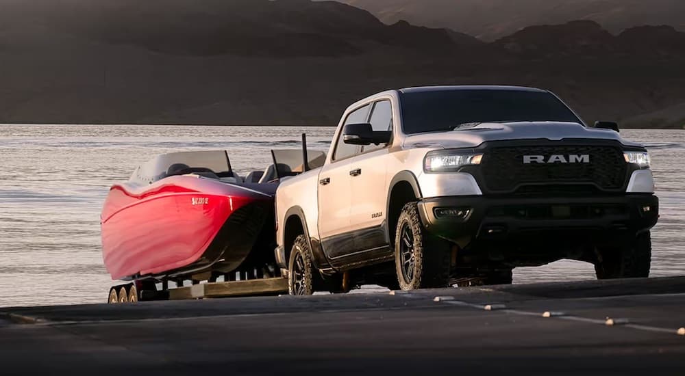 A silver 2025 Ram 1500 Rebel is shown from the front at an angle while loading a boat.