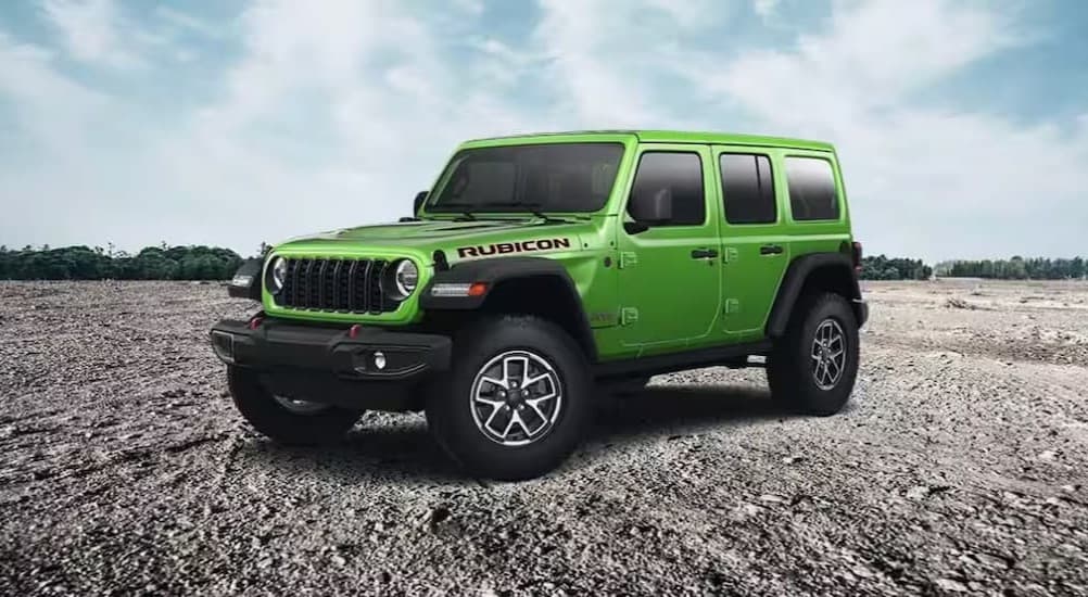 A green 2025 Jeep Wrangler Rubicon parked off-road.
