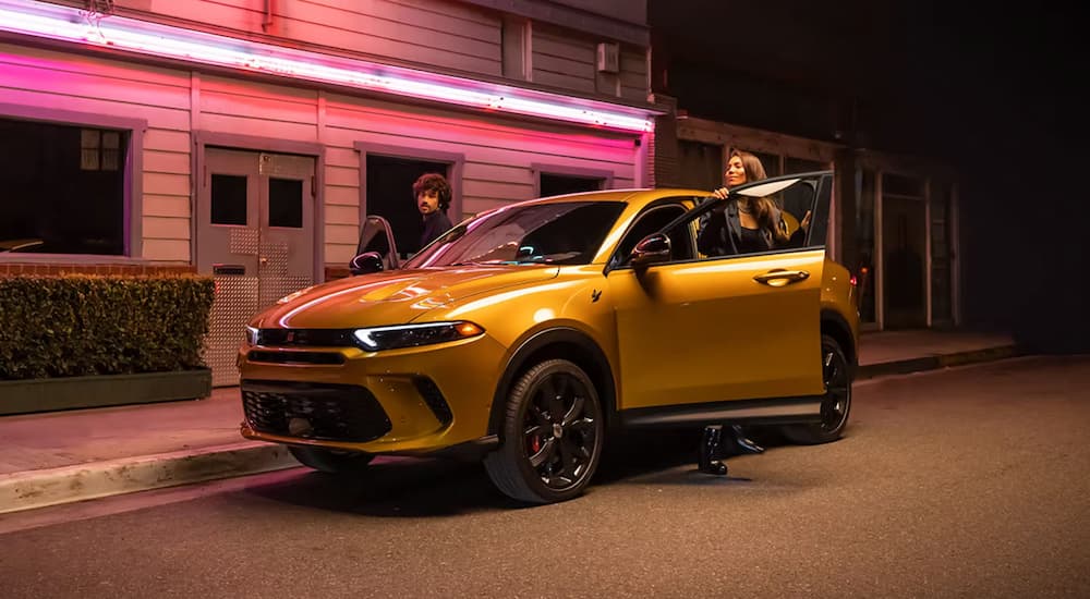 Yellow 2025 Dodge Hornet parked on the side of a street