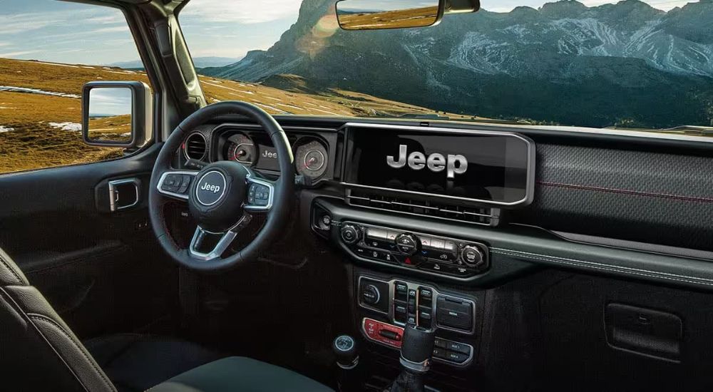 Infotainment display and digital gauge cluster on a 2024 Jeep Wrangler for sale near Peoria