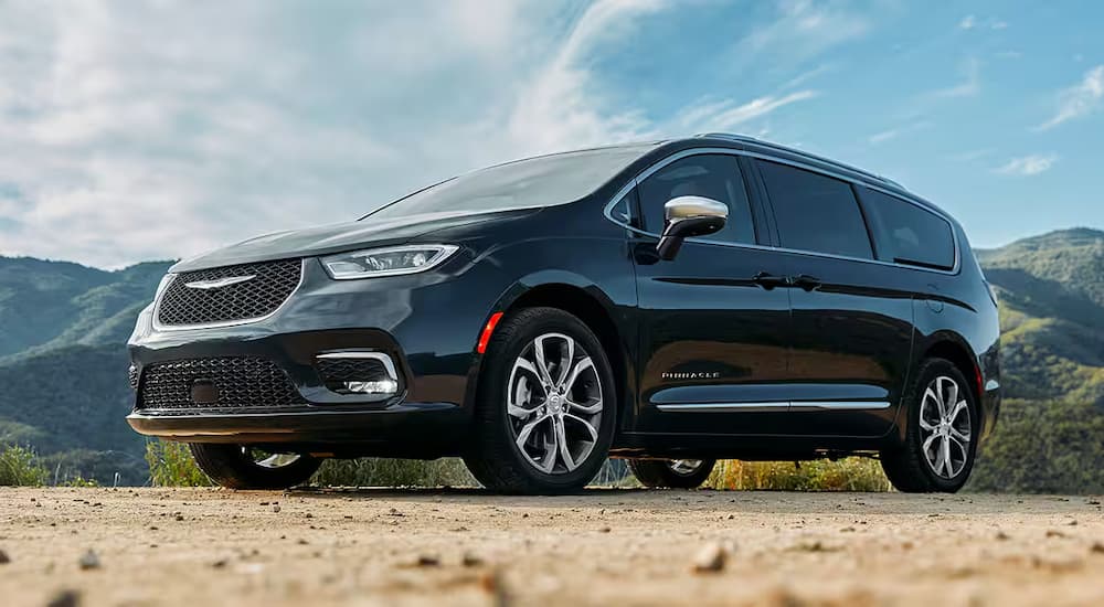 A black 2025 Chrysler Pacifica parked off-road