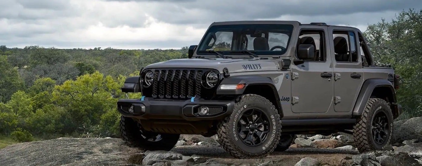 A grey 2023 Jeep Wrangler Willys is shown from the front at an angle.
