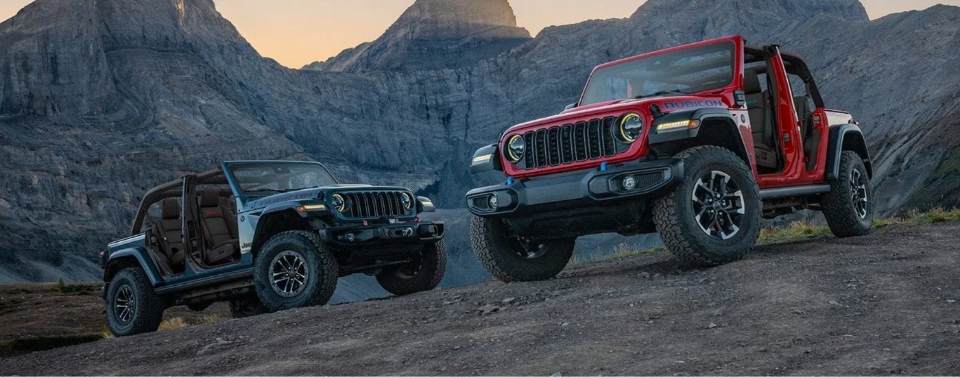 A pair of 2025 Jeep Wranglers parked off-road after leaving a Jeep dealer near Normal.