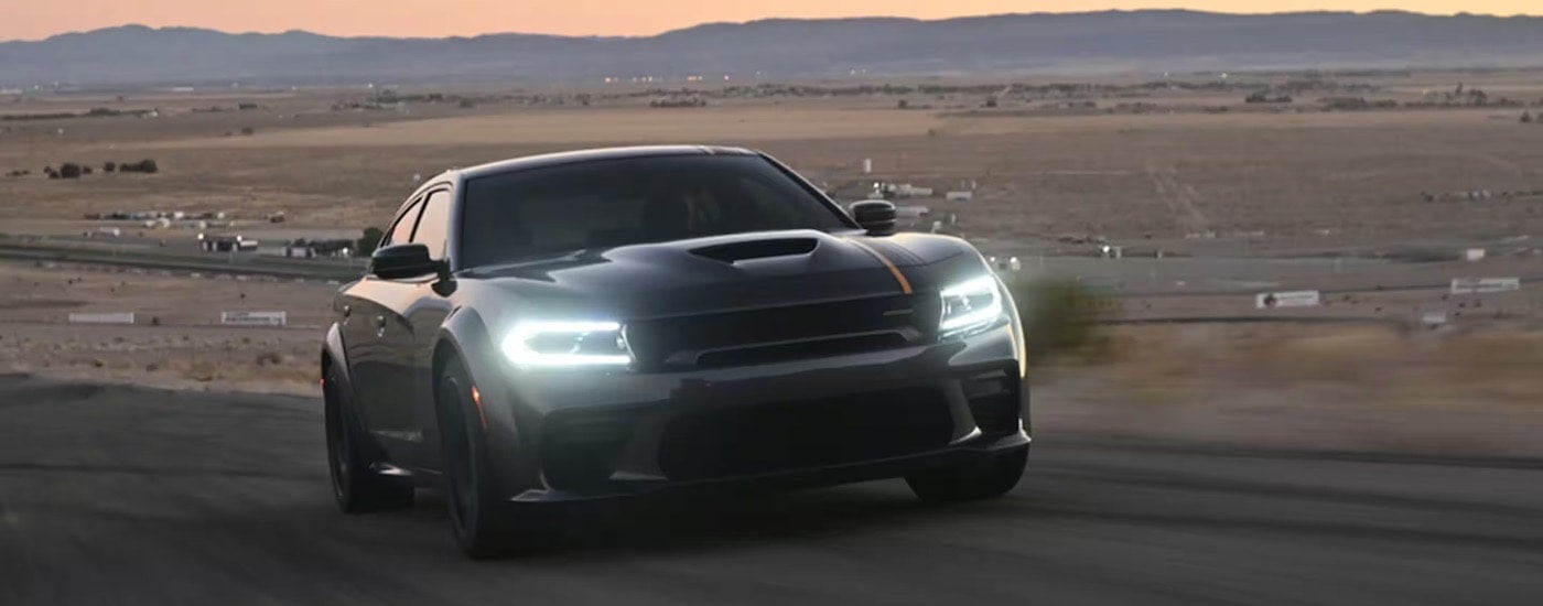 A black 2023 Dodge Charger Scat Pack Widebody is shown from the front at an angle.