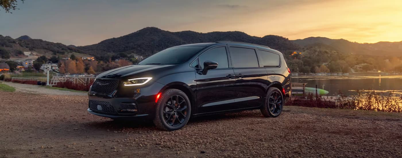 A black 2025 Chrysler Pacifica parked off-road